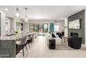 Bright and modern living room with tile flooring, a fireplace, and a view of the outdoor patio at 5250 E Deer Valley Dr # 146, Phoenix, AZ 85054