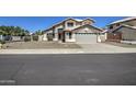 Delightful home featuring a lush front yard, neutral exterior, and a spacious driveway for comfortable suburban living at 5618 W Blackhawk Dr, Glendale, AZ 85308