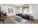 Bright living room with wood floors, large window, and modern decor with stylish furnishings at 624 E Laguna Dr, Tempe, AZ 85282