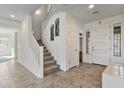 Bright foyer with tiled floors, staircase, and front door, creating an inviting entrance to the home at 1093 E Doral Ave, Gilbert, AZ 85297
