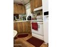 Cozy kitchen features wooden cabinets, laminate floors, and modern appliances at 11596 W Sierra Dawn Blvd # 64, Surprise, AZ 85374