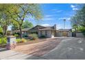 Paver driveway leads to a well-maintained home with mature trees, and a private courtyard entrance at 14821 N Hana Maui Dr, Phoenix, AZ 85022