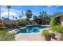 Private pool with mature palm trees, covered outdoor kitchen, and ample space for entertaining at 14821 N Hana Maui Dr, Phoenix, AZ 85022