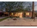 Charming brick home featuring desert landscaping, stepping stones, and a covered parking area at 1513 W Mitchell Dr, Phoenix, AZ 85015