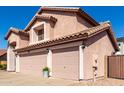 Side angle showing a three-car garage of a charming two-story home at 1737 S Talbot --, Mesa, AZ 85209