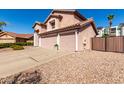 Side angle showing a three-car garage of a charming two-story home at 1737 S Talbot --, Mesa, AZ 85209