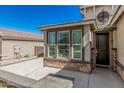 Inviting entryway features stone accents, covered entrance and nearby windows at 17784 W Sandy Rd, Goodyear, AZ 85338