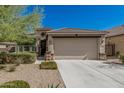 Charming single-story home with a two-car garage, desert landscaping, and a welcoming front entrance at 17784 W Sandy Rd, Goodyear, AZ 85338
