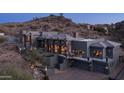 Custom home nestled in a desert landscape, showcasing modern architecture and seamless integration with the natural surroundings at 1805 E Rocky Slope Dr, Phoenix, AZ 85048
