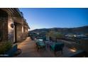 Cozy outdoor patio featuring comfortable seating, a serene fountain, and breathtaking mountain views at twilight at 1805 E Rocky Slope Dr, Phoenix, AZ 85048