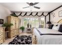 Bright main bedroom featuring elegant decor, a ceiling fan and a bay window at 18867 N Cactus Flower Way, Surprise, AZ 85387