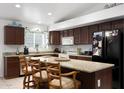Well-lit kitchen featuring a granite island, stainless steel appliances, and ample cabinet space at 20838 N 39Th Dr, Glendale, AZ 85308