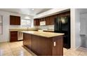Well-equipped kitchen showcasing dark wood cabinets, stainless steel appliances, and a center island at 20838 N 39Th Dr, Glendale, AZ 85308