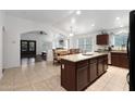 Spacious kitchen featuring a granite island, open dining area, and modern appliances at 20838 N 39Th Dr, Glendale, AZ 85308