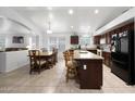 Open-concept kitchen flowing into the dining area with a granite island and modern appliances at 20838 N 39Th Dr, Glendale, AZ 85308