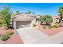 Inviting one-story home with a large driveway, desert landscaping, and a well-maintained tile roof at 22236 N Arrellaga Dr, Sun City West, AZ 85375