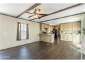 Bright living space with an open floor plan into the kitchen, enhanced by modern dark wood flooring at 255 S 92Nd Pl, Mesa, AZ 85208
