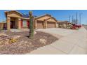 Inviting single-Gathering home with a two-car garage, solar panels, desert landscaping, and a brick-paved walkway at 25536 W Primrose Ln, Buckeye, AZ 85326