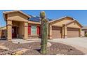 Inviting single-Gathering home with a two-car garage, solar panels, desert landscaping, and a brick-paved walkway at 25536 W Primrose Ln, Buckeye, AZ 85326
