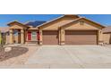 Inviting single-Gathering home with a two-car garage, solar panels, desert landscaping, and a brick-paved walkway at 25536 W Primrose Ln, Buckeye, AZ 85326