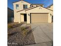 Two-story home featuring a tile roof, two-car garage and low-maintenance desert landscaping at 2672 E Bluff Spring Ave, Apache Junction, AZ 85119