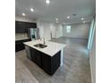 Open-concept kitchen with stainless steel appliances, granite countertops, and seamless transition to the living area at 2672 E Bluff Spring Ave, Apache Junction, AZ 85119
