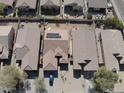 Overhead view of a neighborhood residence with solar panels and small backyard featuring low-maintenance landscaping at 28202 N Willemite Dr, San Tan Valley, AZ 85143