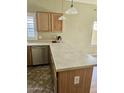 Kitchen with oak cabinets, and island with a bright neutral countertop at 28202 N Willemite Dr, San Tan Valley, AZ 85143