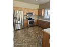 Traditional kitchen featuring stainless steel appliances and honey oak cabinetry at 28202 N Willemite Dr, San Tan Valley, AZ 85143