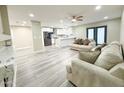 Comfortable living room features gray toned wood floors and easy access to kitchen at 3338 W Palmaire Ave, Phoenix, AZ 85051
