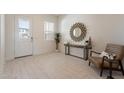 Bright foyer with stylish console table, decorative mirror, and attractive wood-look flooring at 3483 W Sunstone Dr, San Tan Valley, AZ 85144