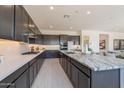Modern kitchen with granite countertops, backsplash, and gray cabinets at 3483 W Sunstone Dr, San Tan Valley, AZ 85144