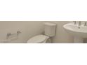 Neat powder room with a toilet, sink, and brushed nickel fixtures at 3483 W Sunstone Dr, San Tan Valley, AZ 85144