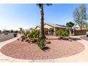 Exterior view of property showing desert landscaping, solar panels, and neighborhood at 3514 W Sands Dr, Glendale, AZ 85310