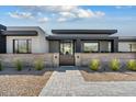 Contemporary home featuring desert landscaping and a gated entrance in a xeriscaped yard at 36004 N Prickley Pear Rd, Cave Creek, AZ 85331