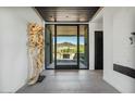 Modern foyer with an open view to the outdoors and desert landscaping at 36004 N Prickley Pear Rd, Cave Creek, AZ 85331