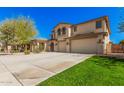 Well-maintained two-story house with a three-car garage and landscaped front yard at 4725 N 152Nd Dr, Goodyear, AZ 85395