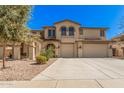 Elegant two-story home featuring a spacious three-car garage and lush landscaping at 4725 N 152Nd Dr, Goodyear, AZ 85395