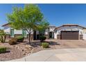 Charming single-story home boasts stucco exterior, landscaped front yard with mature tree and brick paver driveway at 5114 S Leisure Ct, Gilbert, AZ 85298