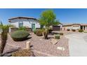Manicured landscaping with mature bushes and rock ground cover enhance the curb appeal of this well-maintained home at 5114 S Leisure Ct, Gilbert, AZ 85298