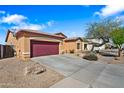 Desert home featuring low-maintenance landscaping, a driveway, and nearby mature tree at 5318 W Grenadine Rd, Laveen, AZ 85339