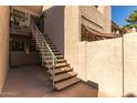 Exterior staircase leading to a second-story unit with a shade canopy at 533 W Guadalupe Rd # 1001, Mesa, AZ 85210