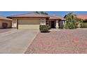 Inviting single-level home featuring a two-car garage, desert landscaping, and a tiled roof at 5358 E Glencove St, Mesa, AZ 85205