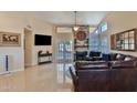 Bright living room featuring a fireplace, tile flooring, and plenty of natural light at 5358 E Glencove St, Mesa, AZ 85205