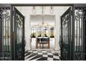 Stunning foyer showcasing black and white tile flooring and elegant lighting that leads to a bright living space at 7046 N 59Th Pl, Paradise Valley, AZ 85253