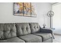 Close up of a comfortable gray sofa with decorative pillows and nearby table with a lamp at 7625 E Camelback Rd # A114, Scottsdale, AZ 85251