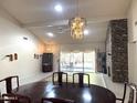 Open dining area featuring a stone fireplace and sliding door access to the outdoor patio at 8552 E Vía Del Palacio --, Scottsdale, AZ 85258