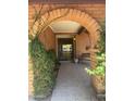Charming front entrance featuring a brick archway and tiled porch, creating an inviting welcome at 8552 E Vía Del Palacio --, Scottsdale, AZ 85258