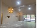 Living room featuring tile floors, decorative wall cutouts, and sliding glass doors at 8552 E Vía Del Palacio --, Scottsdale, AZ 85258