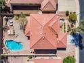 Aerial view showcasing a home's roof, a pool and a landscaped yard and patio area at 8817 S 13Th Way, Phoenix, AZ 85042